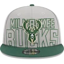 shapka-ploska-siv-snapbek-9fifty-draft-edition-2023-na-milwaukee-bucks-nba-ot-new-era