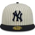 beige-und-marineblaues-59fifty-retro-script-fitted-cap-der-new-york-yankees-mlb-von-new-era